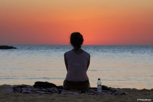 woman_sitting_and_watching_sunset_at_the_beach-other